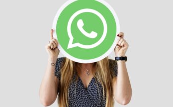 woman showing whatsapp messenger icon min